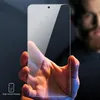 A hand holds a glass screen protector in front of a blurred person. Produktbild-Vorschau