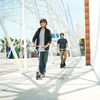 Two young men riding scooters on a sunny day. Produktbild-Vorschau