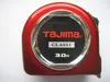 A close-up, front-facing view of a red Tajima tape measure. Voir les images du produit