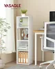 A white four-tier shelf unit filled with books, headphones, and binders, placed next to a window with sheer curtains and a desk with a chair. Produktbild-Vorschau