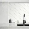 A modern kitchen countertop with a marble-look backsplash and sink area. Produktbild-Vorschau