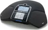 A black Konftel conference phone is shown from a slightly elevated front-left angle on a white background. Náhled obrázku produktu