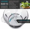 A close-up of a food chopper with ingredients and a recipe for pesto shown in the background. Produktbild-Vorschau