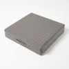 A gray quilted seat cushion with a handle on a white background. Náhled obrázku produktu