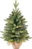 A small artificial Christmas tree in a pot, wrapped in burlap. Voir les images du produit