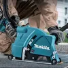 A person wearing work clothes and gloves is using a Makita concrete cutting tool on a paved surface. Anteprima dell’immagine prodotto