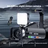 A digital camera with accessories is displayed in a scenic outdoor setting with water and rocks. Produktbild-Vorschau