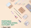 A flat lay of a portable stainless steel cutlery set with its packaging and accessories, arranged on a light beige background. Náhľad obrázku produktu