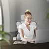A woman is working on a laptop while sitting in an ergonomic office chair. Produktbild-Vorschau