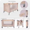 An image showing a baby travel cot and its folding mechanism, along with a carrying bag. Náhled obrázku produktu