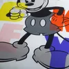 A close-up of a Mickey Mouse graphic with large, colorful letters in the background. Produktbild-Vorschau