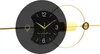 A modern wall clock with a black and gold design. Anteprima dell’immagine prodotto