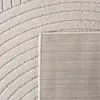 A close-up view of a rug, showing its texture and pattern, with the backing visible in the corner. Podgląd zdjęcia produktu