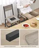 A person is sitting at a table with two chairs, one of which has a tablet placed on it. Produktbild-Vorschau