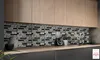 A kitchen counter with backsplash tiles, a blender, and decorative items. Náhled obrázku produktu