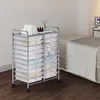 A rolling cart with many drawers sits next to a bed in a room. Podgląd zdjęcia produktu