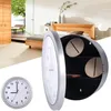 A bedroom scene with a wall clock that opens to reveal a hidden compartment. Voir les images du produit