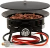 A black gas fire pit with lava rocks inside, a lid partially open, and a red gas hose connected to a regulator. Produktbild-Vorschau