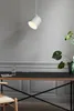 A modern desk setup with a pendant light, a glass of water, and a plant. Voir les images du produit