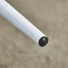 A close-up view of the end of a white cylindrical object with a black cap. Produktbild-Vorschau