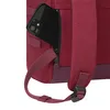 A close-up view of a red backpack with a black smartphone partially inserted into a zippered pocket. Produktbild-Vorschau