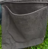 A close-up of a gray terry cloth cover for a lounge chair, showing a side pocket. Produktbild-Vorschau
