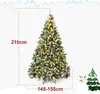A decorated artificial Christmas tree with lights and snow, with size indicators and a snowman and another tree illustration on the side. Produktbild-Vorschau