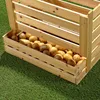 A wooden crate filled with potatoes, sitting on artificial grass. Podgląd zdjęcia produktu
