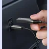 A hand is plugging a Ugreen Bluetooth audio adapter into a USB port in a car. Produktbild-Vorschau