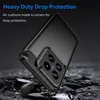 A black phone case is shown at an angle, resting on a dark, rocky surface. The background is dark and blurred. Produktbild-Vorschau