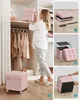 A woman is organizing a closet and demonstrating how to assemble a pink storage ottoman. Náhled obrázku produktu