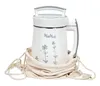A white MioMat plant-based drink maker sits on a white background, partially covered by a beige drawstring bag. Produktbild-Vorschau