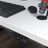 A close-up view of a white standing desk with a black keyboard, mouse, and microphone. The desk has a control panel with digital display and buttons. Podgląd zdjęcia produktu