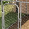 A close-up view of a metal dog kennel gate with chicken wire mesh. Podgląd zdjęcia produktu