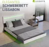 A modern bedroom with a white floating bed with green LED lighting. Náhľad obrázku produktu