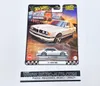 A Hot Wheels Premium collectible car in its packaging, displayed against a white background. The packaging features artwork of a white BMW M5 and a drive-in movie theater scene. Voir les images du produit