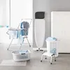 A laundry room scene with a drying rack, ironing board, and laundry baskets. Produktbild-Vorschau