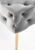 A close-up view of a tufted upholstered bench with a gold leg. Produktbild-Vorschau