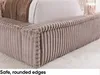 Close-up view of the corner of a bed frame with a textured, cord-like fabric. Produktbild-Vorschau