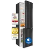 A black refrigerator with its doors open, displaying internal shelves and drawers. Several marketing badges and a sound icon overlay are visible on the left and right sides of the refrigerator. Produktbild-Vorschau