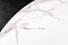 A close-up view of a white marble-patterned surface with gray veining, adjacent to a black area. Produktbild-Vorschau