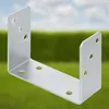 A silver U-shaped metal bracket is shown against a blurred background of green foliage and a blue sky. Podgląd zdjęcia produktu