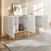 A modern white sideboard with open doors, displaying interior shelves and items, set in a well-lit room with a rug and wall decor. Náhľad obrázku produktu