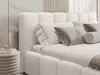 A close-up view of a white bouclé fabric bed with pillows and a throw blanket. Produktbild-Vorschau