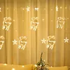 Christmas lights in the shape of reindeer and stars hanging on a yellow curtain. Produktbild-Vorschau