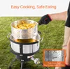 A person is using a deep fryer outdoors on a grassy area. Produktbild-Vorschau
