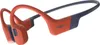 A pair of red and blue Shokz sports headphones against a white background. Náhľad obrázku produktu