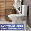 A toilet with the lid open, in a bathroom setting with a wicker basket and bathrobe. Produktbild-Vorschau