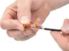 Hands holding and inserting a wire into a WAGO connector. Anteprima dell’immagine prodotto