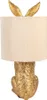 A gold-colored rabbit-shaped table lamp with a cream-colored lampshade. Produktbild-Vorschau